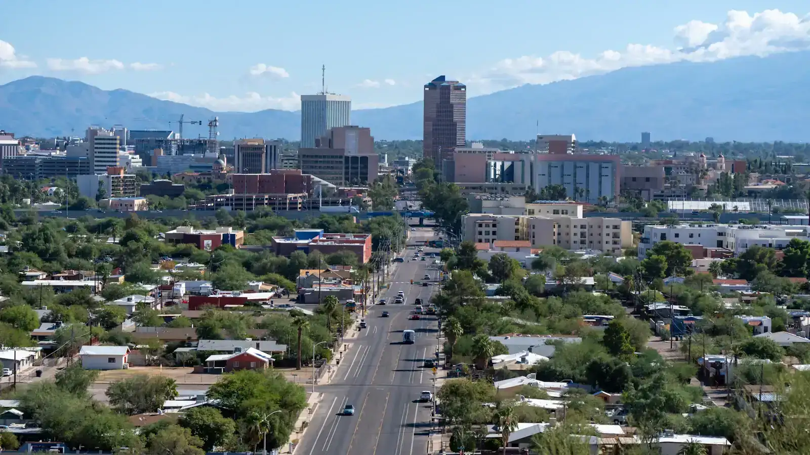 Downtown Tucson and a tree-lined street with the Santa Catalina Mountains behind